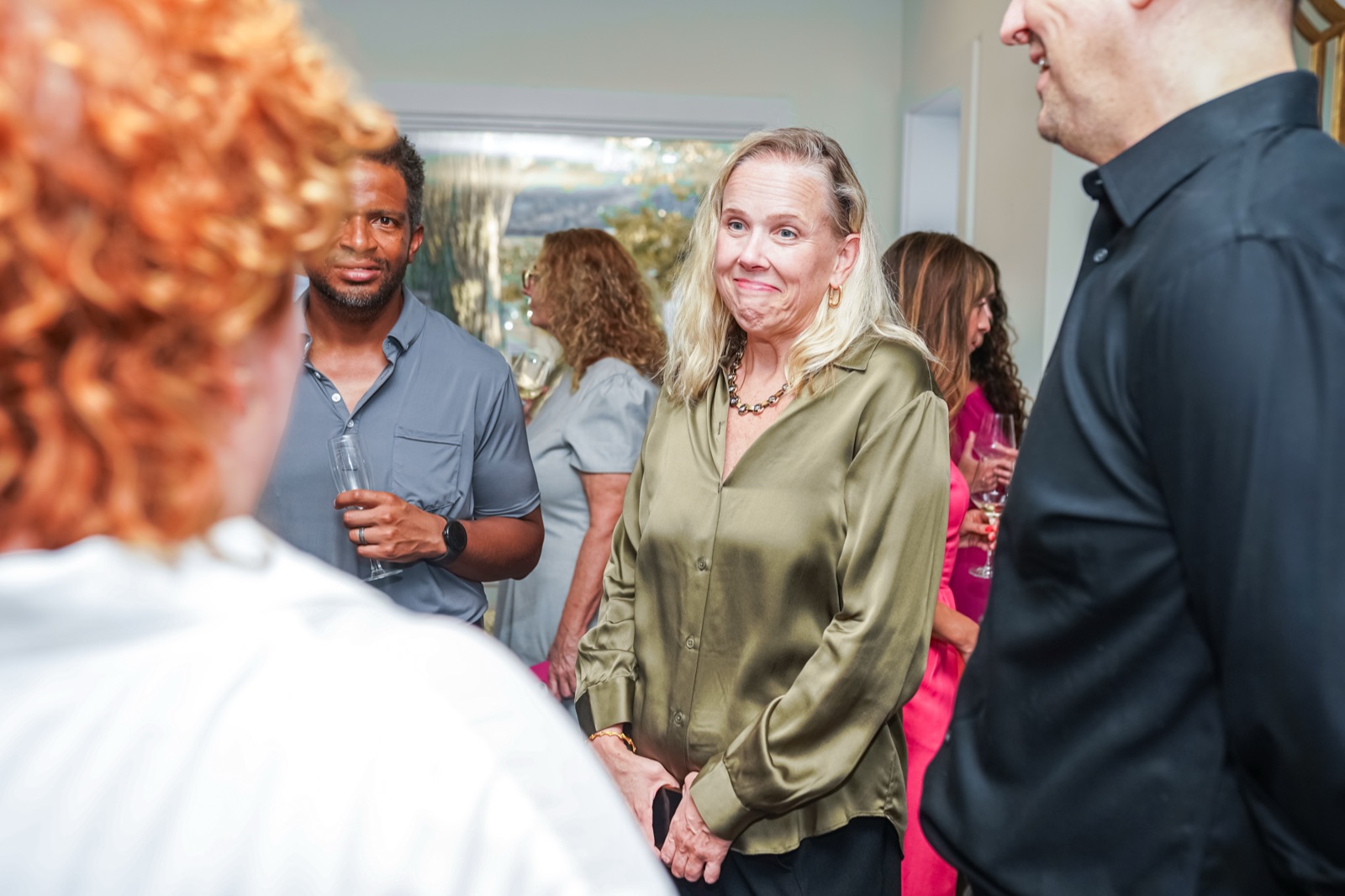 Guests networking in small groups at a DC Fiduciaries event.